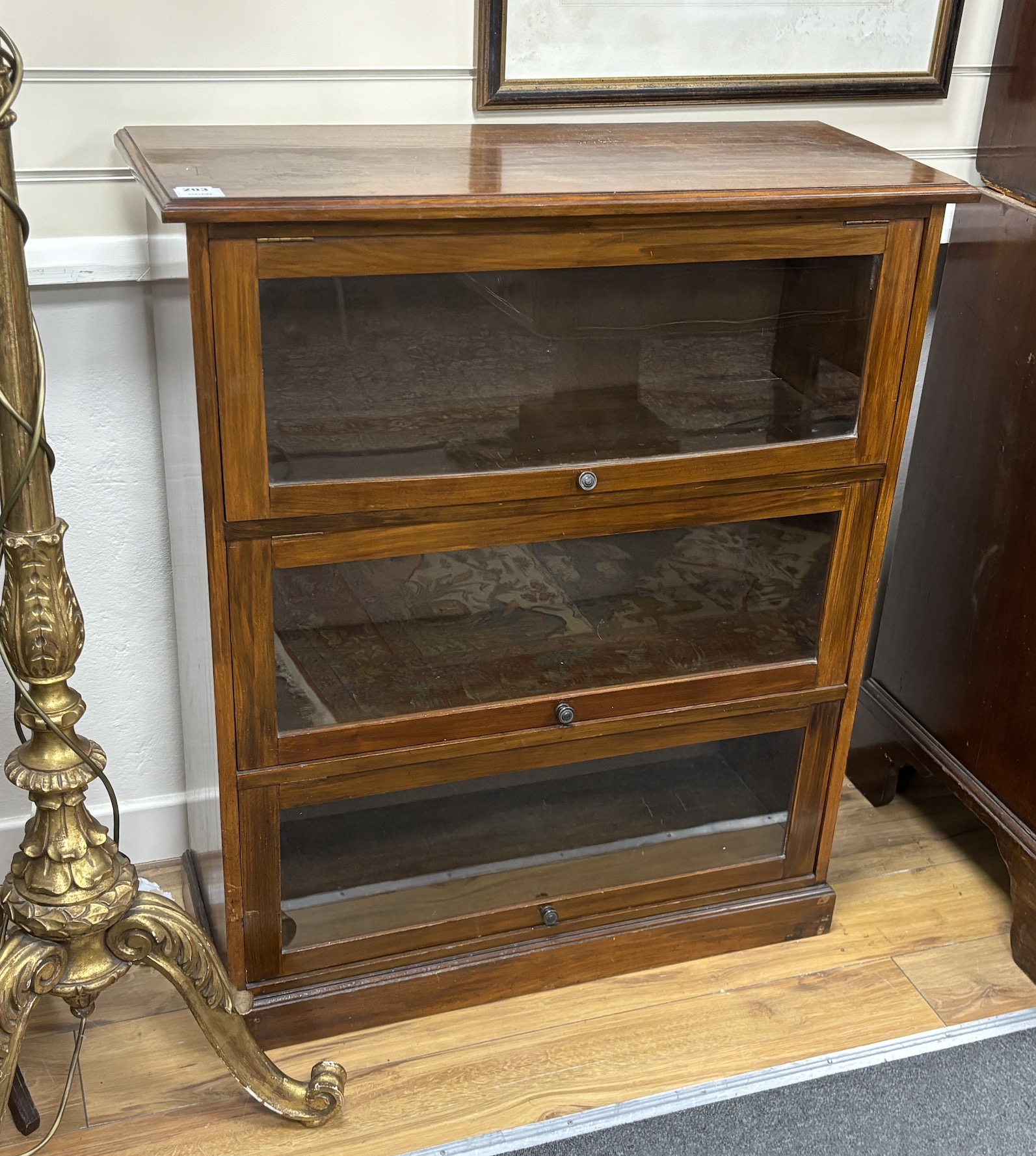 A glazed mahogany three door bookcase, width 82cm, depth 34cm, height 99cm